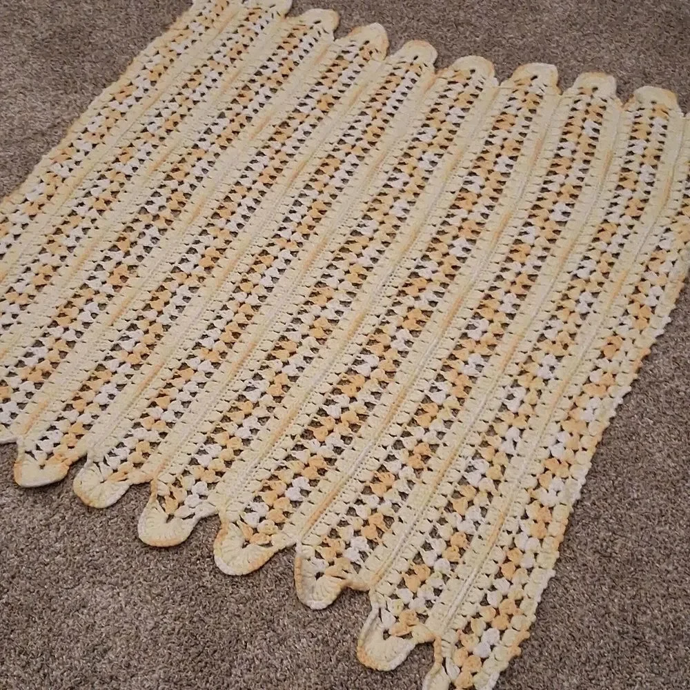 Handmade yellow and white crocheted baby‎ blanket with a scalloped edge